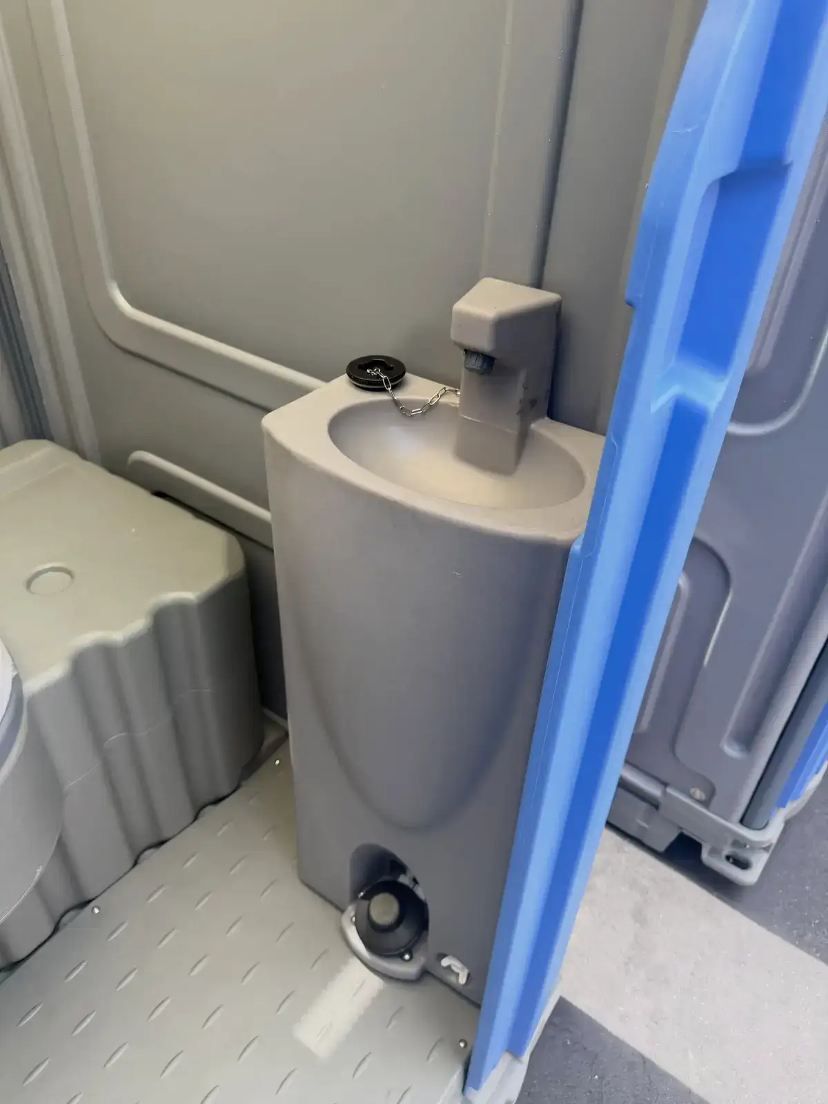 Built-in hand sink inside a deluxe portable toilet