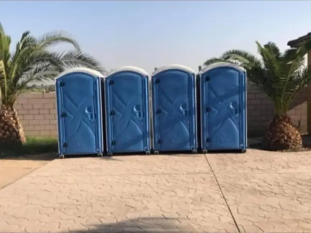 Row of clean event porta potties on a paved lot